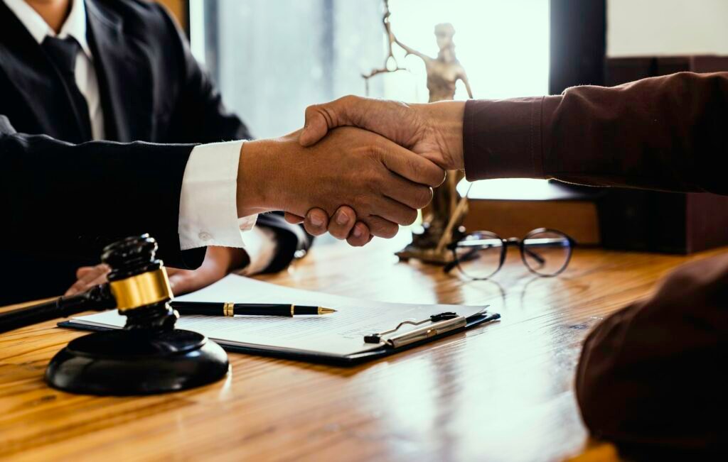 Handshake after good cooperation, Consultation between a male lawyer and businessman customer, tax a